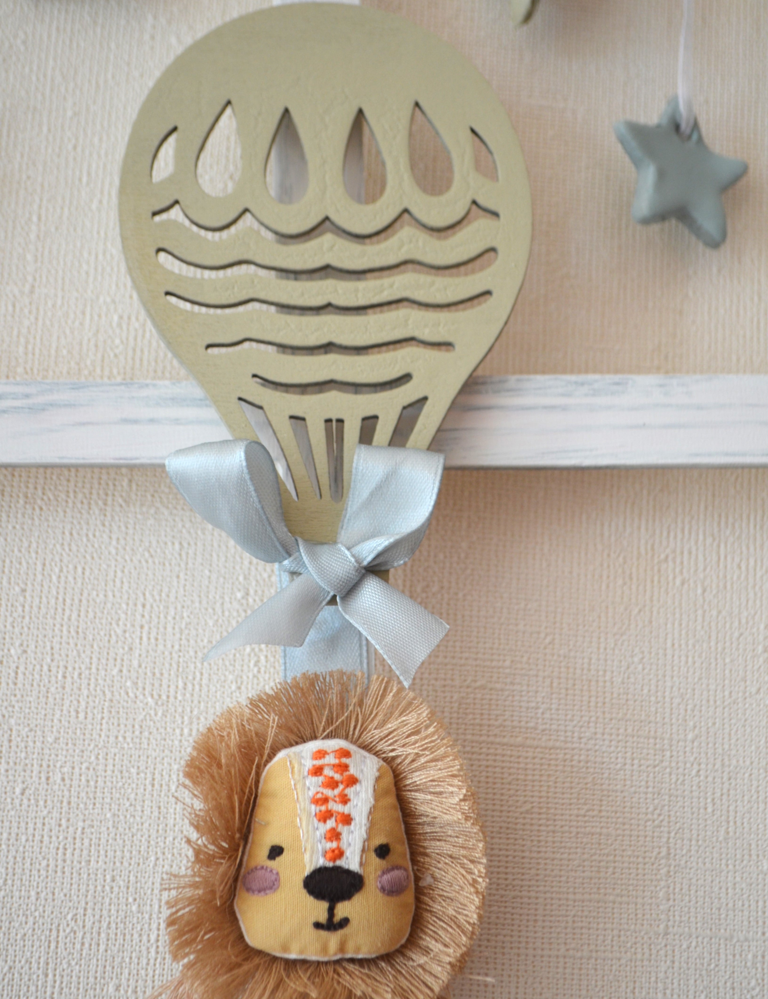 Detalle cuadro infantil con forma de ventana con león y globo aerostático Lily Garden  deco